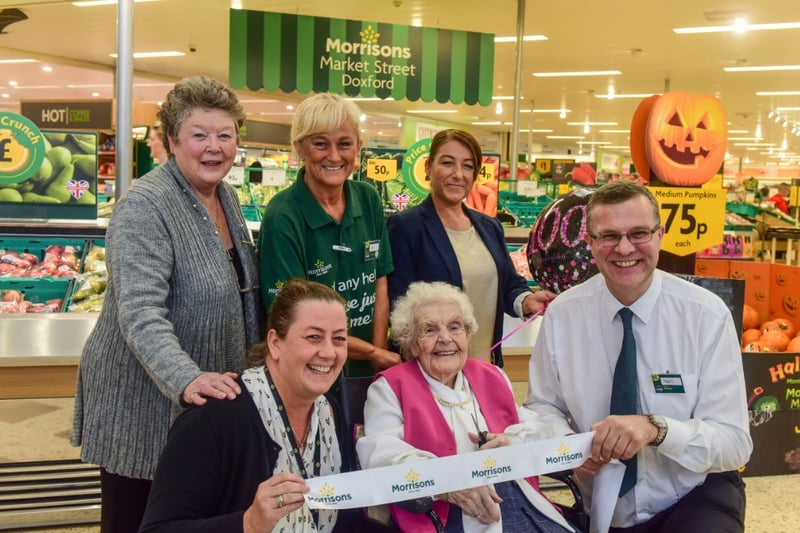 The re-launch of the Doxford Park store in 2016, and 100-year-old Charlotte Deacon cut the ribbon with store staff, family and friends watching.