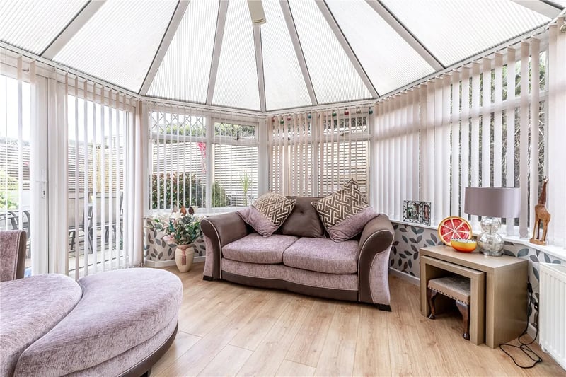The gorgeous conservatory offers panoramic views of the garden.