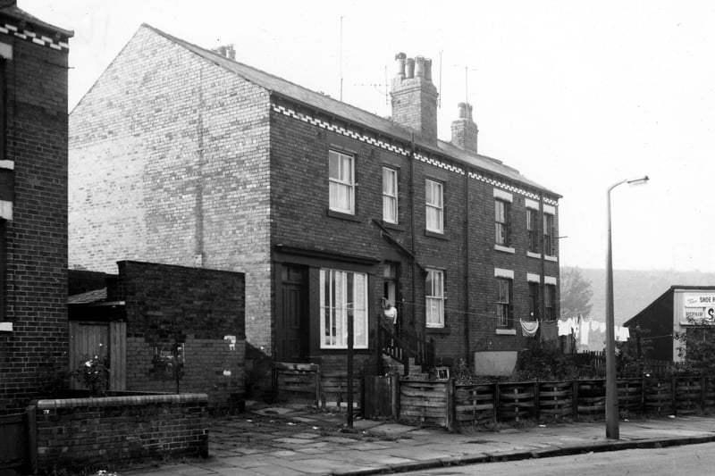 Two properties on Cow Close Road. Number 39 is on the left. This property has two entrances, on with a shop window. Number 41 follows to the right. The properties sit between outside toilet blocks. Pictured in October 1969.