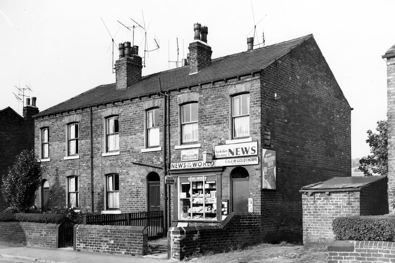 A block of three properties on Cow Close Road pictured in  October 1969. In focus is a  newsagents run by C. & J.M. Goldthorpe. Advertisements for News of the World and the Yorkshire Evening News are visible along with posters for Lyons Maid ice cream and Windowlene spray. 