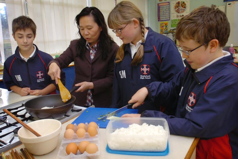 Jane Jia Yan was teaching Chinese cookery to Sunderland High School pupils Ryan Hancock, Sam Harris and Josh Harper in October 2010.