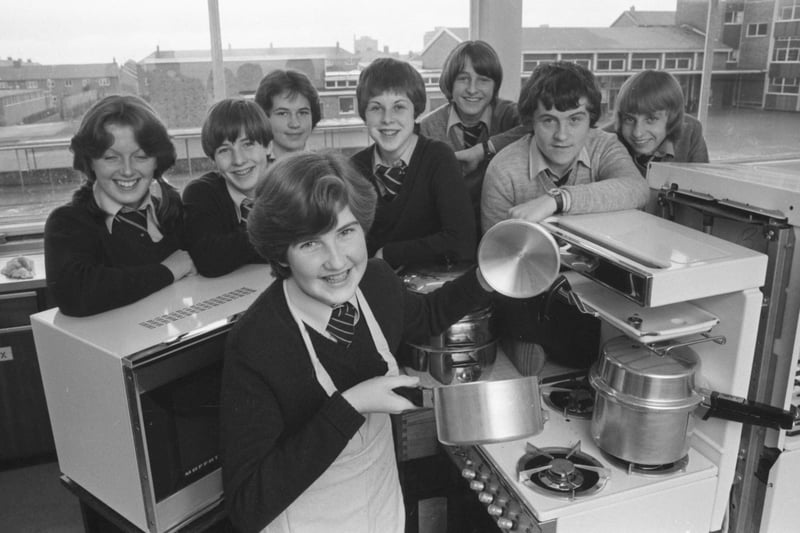 Alison Kell, 14, tries her hand at one of the energy-saving cooking methods as other pupils involved in the Farringdon School experiment look on in 1979.