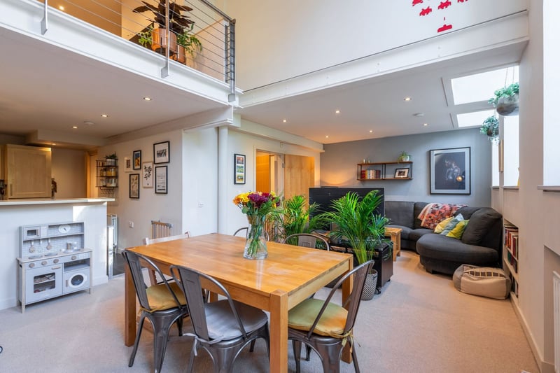 Entering the property on the ground floor which comprises a welcoming hallway, shower room with WC, large utility room with storage and a grand open plan living/dining room/kitchen with charming original large windows