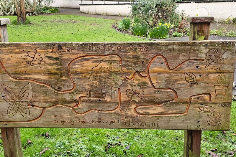 There are multiple signs with designs made by children in the Garden of Fragrance including this one by Sophie Evans, aged 11, which encourages visitors to use their different senses to enjoy nature.
