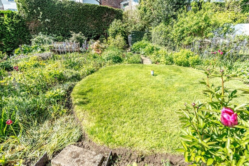 The rear garden has a great mixture of uses, with a lawn space for kids to play, flowers and plants for wildlife, and a seating area.