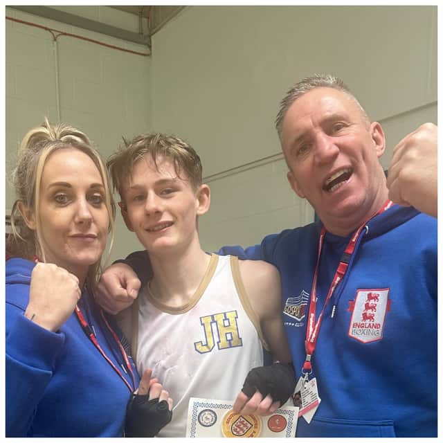 Darren Blair with young boxer Jack Harrop, centre, and Blair's partner and Jack's mother Leandra Hunter, left