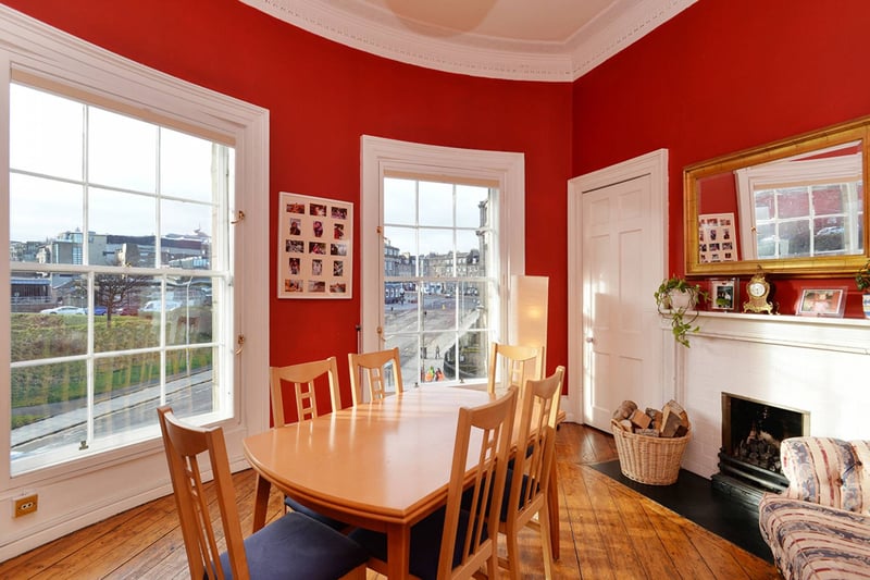The elegant dining room is adjacent to the living room and boasts curved walls that are such a sought-after quirk of the architecture in the New Town. The room has two large sash and case windows that overlook London Road and have views toward the city centre. There is ample space for a large dining table and supporting furniture. 