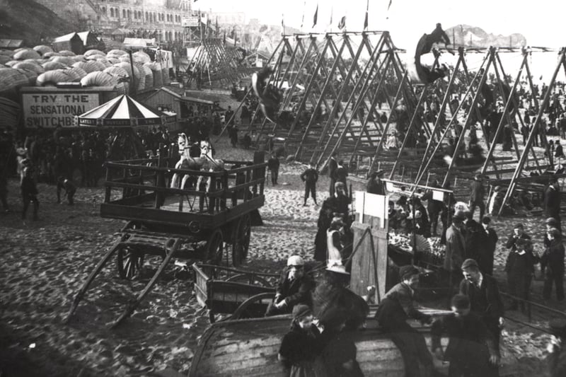  Depicting the bathing machines to the rear left of the picture. There are kiosks selling tea snacks and souvenirs. The swings to the right were locally known as shuggy boats.