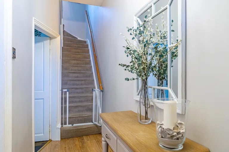 A spacious entry hallway leads to the ground floor rooms and to the first floor.