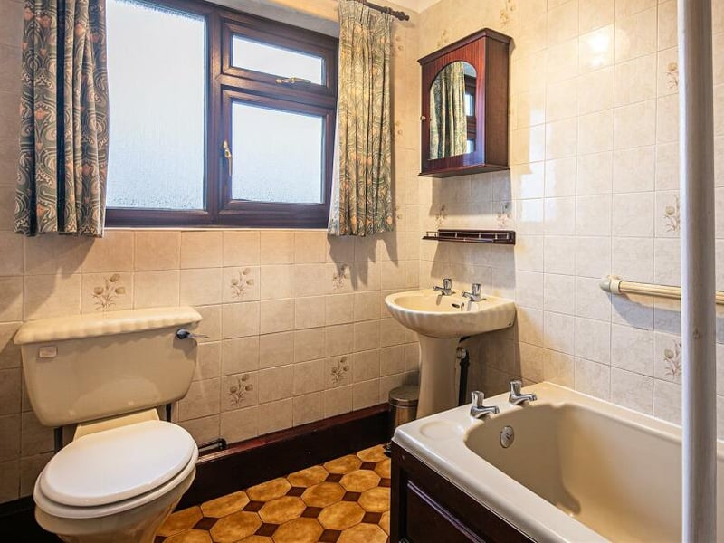 The bathroom has a simple, traditional design currently.