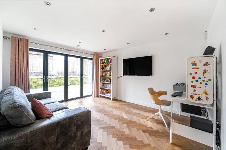 The superb home features a large sitting room with bi-folding doors to the garden.