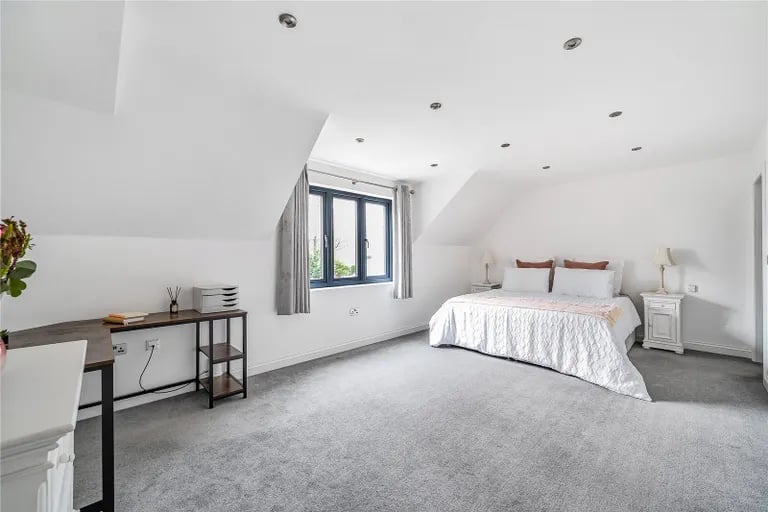 On the second floor is a fifth bedroom - a large double with skylight windows and eaves.