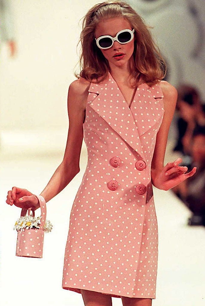 Teenage model Jodie Kidd presents a pink Tomasz Starzewski Summer coat and matching handbag during his Spring-Summer 1996 ready-to-wear show on the fourth day of London fashion Week 23 October. AFP PHOTO  (Photo credit should read ANDREW WINNING/AFP via Getty Images)