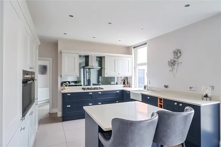 The kitchen is equipped with Shaker-style units, Belfast sink and a range of built-in appliances and Quartz worktops.