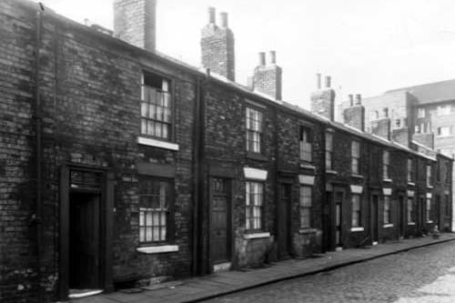 Odd numbered back-to-back houses on Hampden Street, numbers run to the right in ascending order from number 5 on the left. Shaftesbury House can be seen on the right edge. This area of Beeston was redeveloped after slum clearance. Pictured in April 1959.
