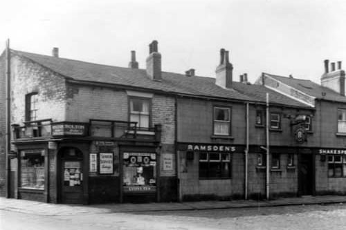 On the left edge of this view is Harry Bolton's bakers and confectioners which was at number 20 Lady Pit Lane. On the right is the Ramsdens Ales owned Shakespeare Inn, which had Fred Smith as the landlord at this time and had a smoke room to the left and a tap room to the right. This area was substantially altered after slum clearance. Pictured in April 1959.