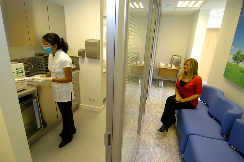 Inside The Strand dental clinic in May 2007. Pictured is dental nurse Sushma Pandey working in the  sterilising rooms while a patient looks on.