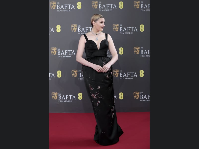 Barbie director Greta Gerwig posing on the 2024 Bafta red carpet. 