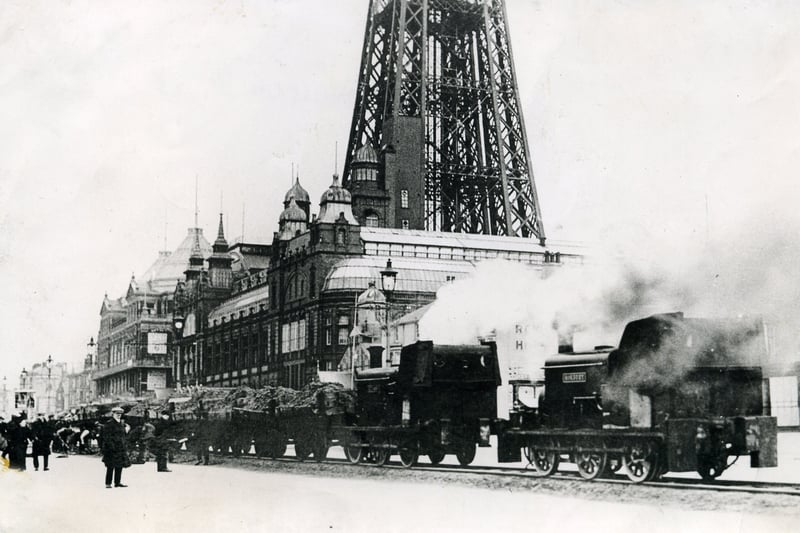The Sands Express in 1911 was a temporary steam railway on the seafront. Here it is, chugging along in teh shadows of the tower. 