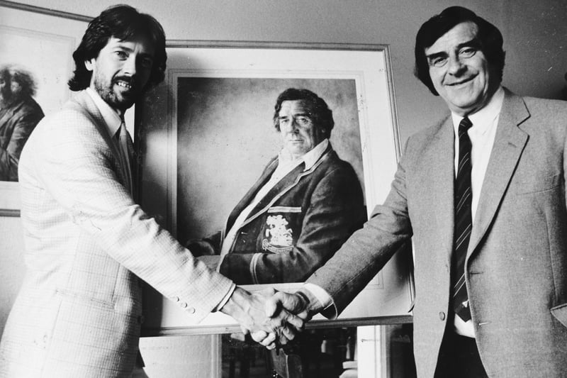 Artist John Blakey shakes hands with his boyhood hero Fred Trueman in front of a watercolour tribute to the cricketer in May 1986.
