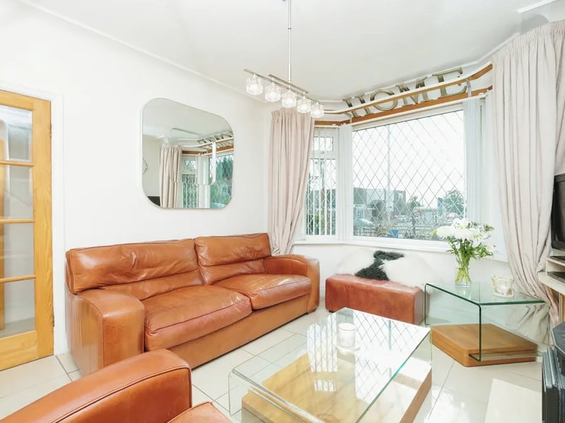 The gorgeous reception room features a large bay window overlooking the front elevation.