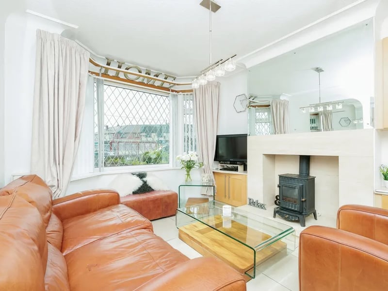 As you step into the property you and greeted by this reception room with fireplace.