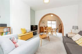 The living room features a unique arch feature separating the lounge and dining areas. (Photo courtesy of Zoopla)
