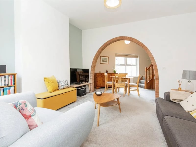 The living room features a unique arch feature separating the lounge and dining areas. (Photo courtesy of Zoopla)