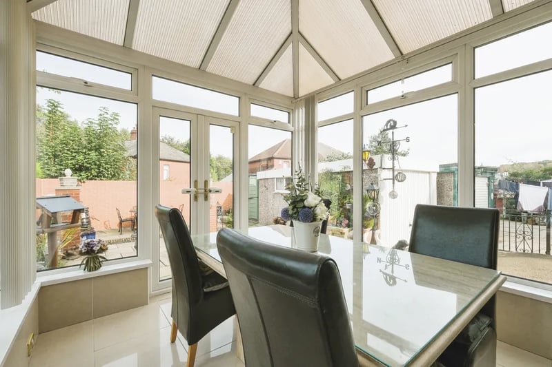 The bright conservatory is a great place to entertain guests and has direct view and access to the garden.