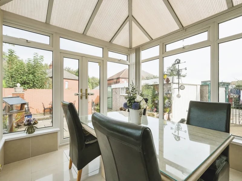The bright conservatory is a great place to entertain guests and has direct view and access to the garden.