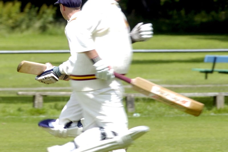 Hall Park's Geoff Barker, left, and Peter Kempton, right, run past each other on the crease during the Airedale and Wharfedale League Division B clash against Tong Park in July 2007.
