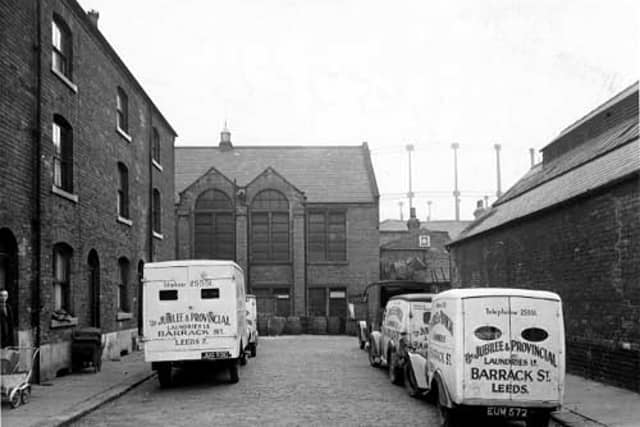 This view looks south-west down Clarence Square at the rear of Sheepscar Congregational Chapel. In the foreground are several vans from The Jubilee & Provincial Laundries Ltd., on Barrack Street. In the distance a gasholder is visible. Pictured in October 1946.