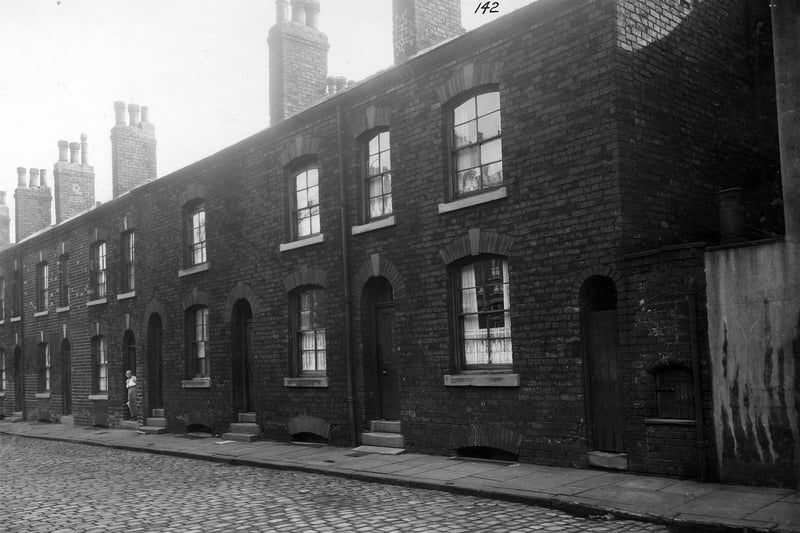 Wright Street, a street of brick built terrace houses off York Road (the junction adjacent to number 107 York Road). Wright Street was located opposite York Road swimming baths. An elderly woman, identified as Mrs. Burrows stands in the doorway of her home of number 10 Wright Street. Pictured in September 1935.