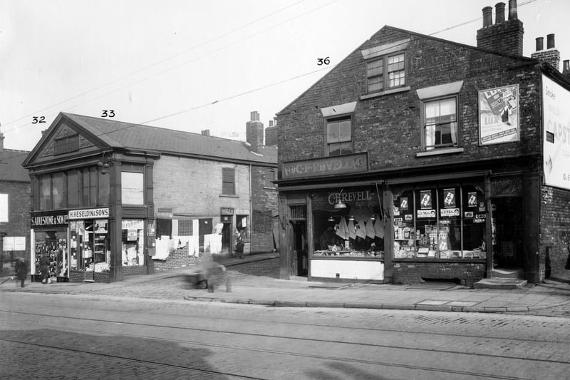 On the left no.39 S. Adlestone and sons boot dealers, next on right no.41 Herbert Heseldin and sons, pawnbrokers. Goods from shop hanging on wall to side of shop on Edgar Street. No.43 butchers shop of Charles Revell, then no.45 William Hudson grocer. Pictured in September 1935.