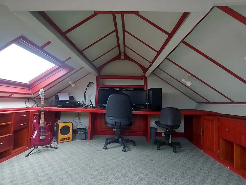 The attic is a large versatile space with Velux windows currently used as an office.