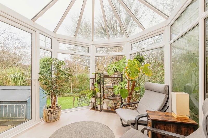 This space is flooding with natural light and offers a gorgeous panoramic view of the rear garden.