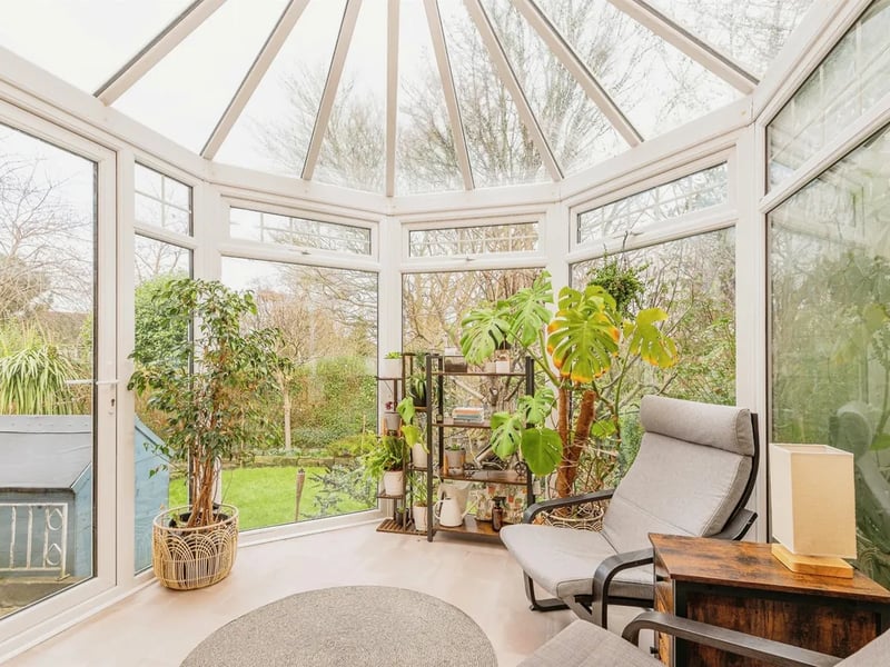 This space is flooding with natural light and offers a gorgeous panoramic view of the rear garden.