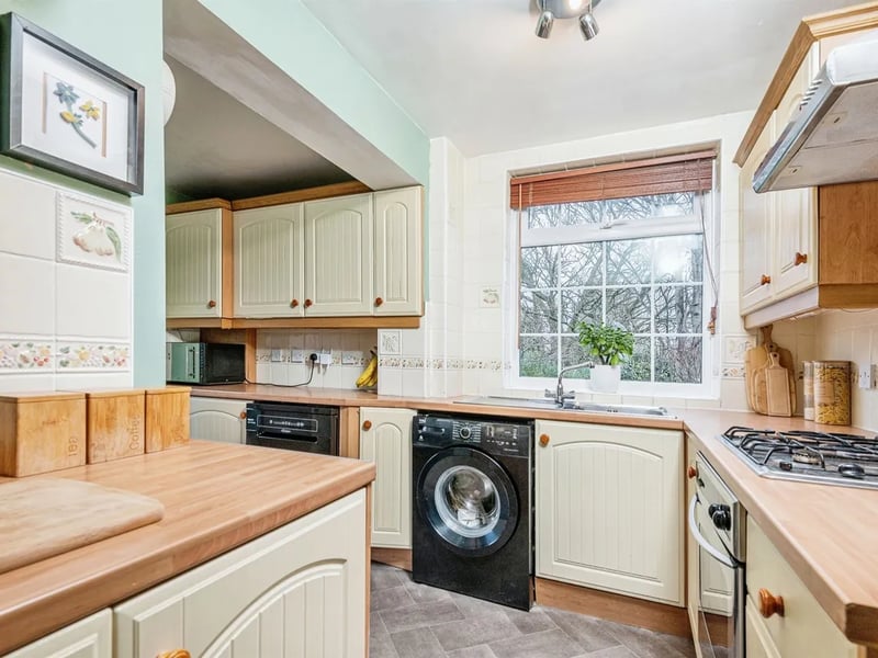 The fitted kitchen features lots of storage with wall hung, drawer and base units.