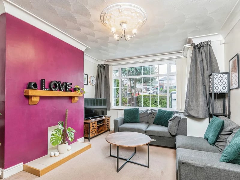 The spacious family lounge is carpeted and has a large window overlooking the front elevation.