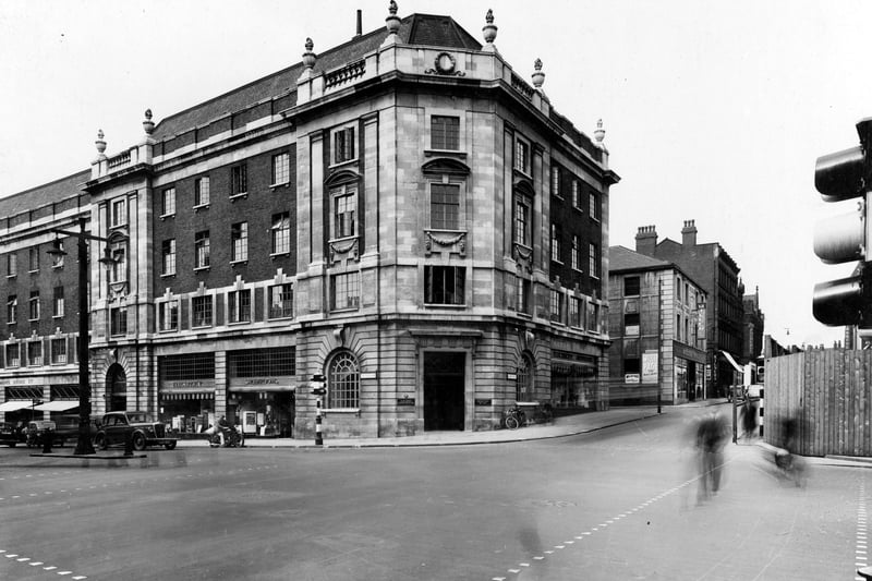 Electricity Showrooms on The Headrow next to the Tax Offices on the corner. There is an entrance to the Electricity Showrooms also on Albion Street. Cars and motorcyles can be seen at the traffic lights. Pictured in August 1939.