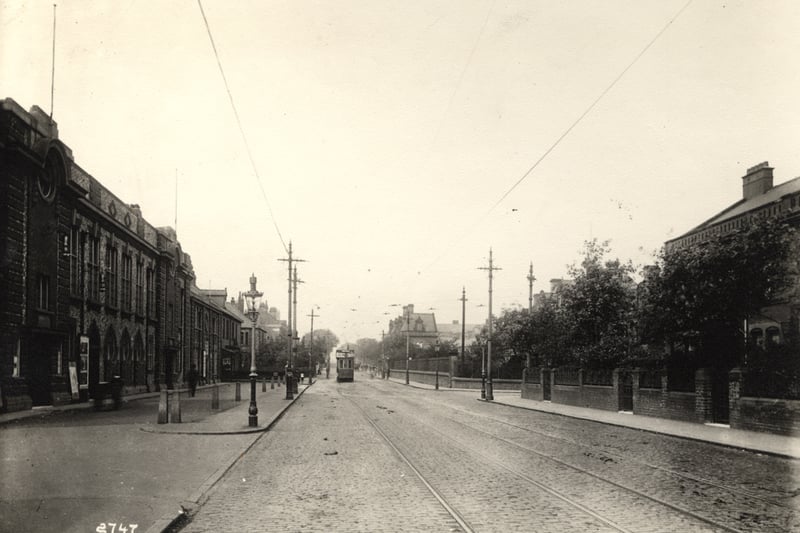  The photograph shows a view along Westgate Road. a tram is travelling along lines. 