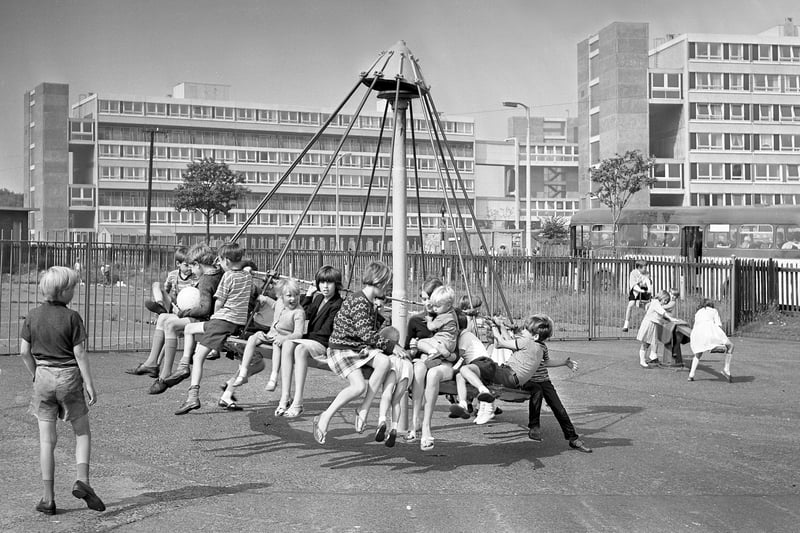 Children in the Thompson Park, Sunderland play area, enjoying themselves on the "witches hat".