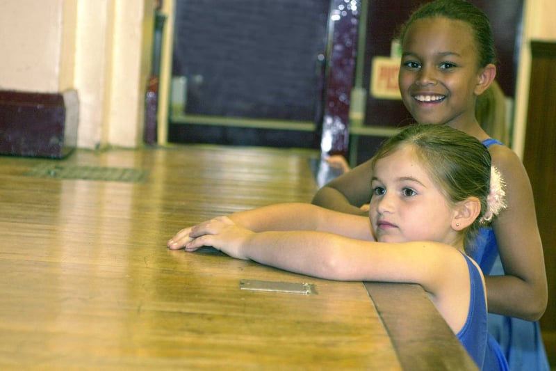 Dancers of the Helen Lamb Tap School were raising money for CARE International UK by dancing non-stop for two hours at Blackburn Hall in June 2000. Pictured are two girls watching the dancers on stage, while they have a break.