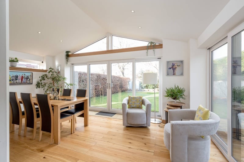 The extension includes this impressive triple aspect family room with patio doors to the garden.
