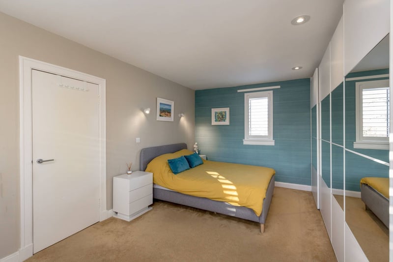 The principle bedroom, with a triple aspect and extensive built-in-wardrobes.