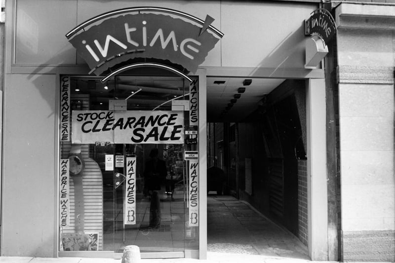  Intime Jewellers at no. 24 Lands Lane. Posters advertise a stock clearance sale with watches at half price. A passageway on the right leads to the back of the shop. Pictured in April 1989.