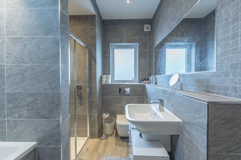 The en-suite bathroom is fitted with a white three-piece suite with separate shower compartment. 