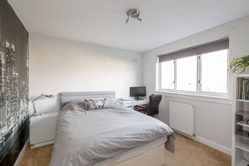 The property's second double bedroom includes handy storage cupboards.