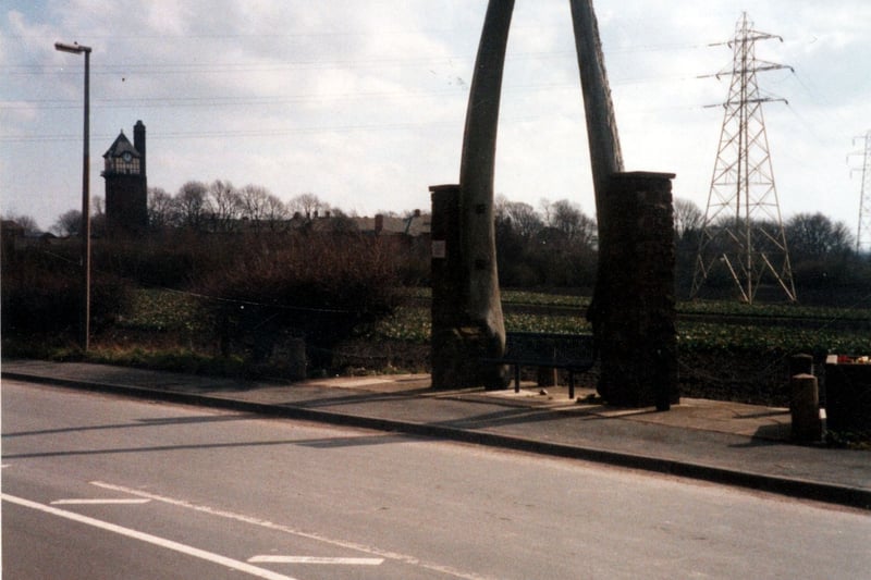 The third pair of Jawbones on Wood Lane pictured in March 2002. They were purchased by the district council after the last pair became damaged in 1967. Bought from the Norwegians for £50 the bones originally belonged to a 75 foot long female Fin Whale. Despite problems with customs and duties the whale bones were eventually put up on Wood Lane becoming the jaw bone junction marker for Wood Lane and the Leeds and Wakefield Road. The first pair of jaw bones were brought back from America in the first half of the 19th century by one of the Fenton family, colliery owners and landowners of Rothwell. 