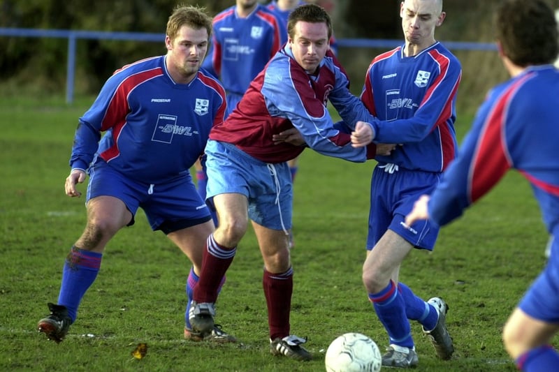 Match action from Rothwell v Carlton in November 2003.
Carlton's Lee McGuire muscles his way past Rothwell's Jody Thirkell and Andrew Kitchen.